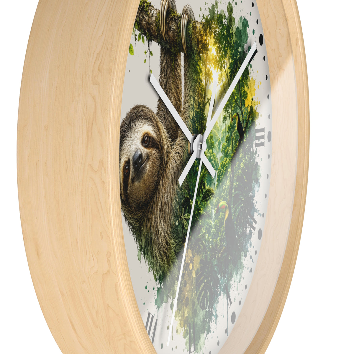 A round wall clock with a light natural wood frame and a printed face showing a sloth hanging from a tree branch above a green forest scene. The clock has white hands and black Roman numerals, photographed on a plain white background.
