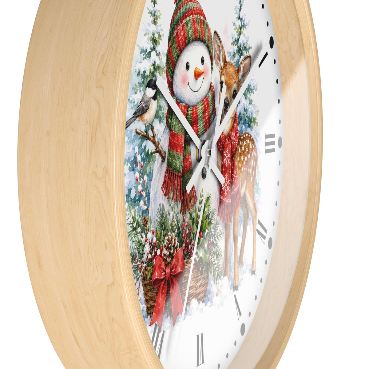 A round wall clock with a light natural wood frame and a white face featuring a festive winter illustration of a snowman, a deer, a bird, and evergreen branches. The clock is shown at an angle against a plain white background.
