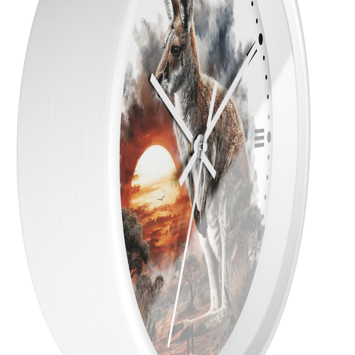 A white round wall clock featuring a printed scenic artwork of a kangaroo in front of a dramatic sunset sky, with white clock hands and no visible brand text.