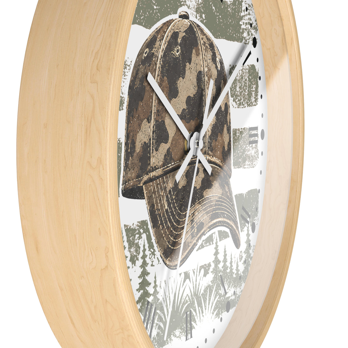 Oval wall clock with a light natural wood frame and a printed face featuring a camouflage baseball cap over a forest scene.