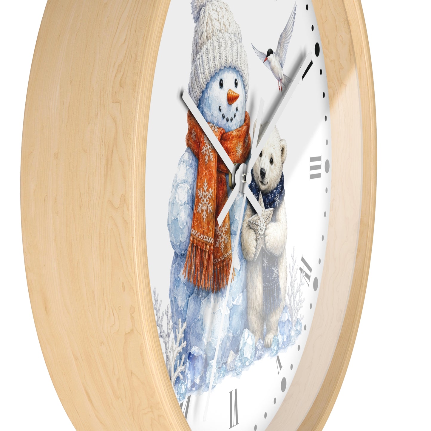 A round wall clock with a light natural wood frame and a white face featuring a winter illustration of a snowman in a knit hat and scarf next to a teddy bear.