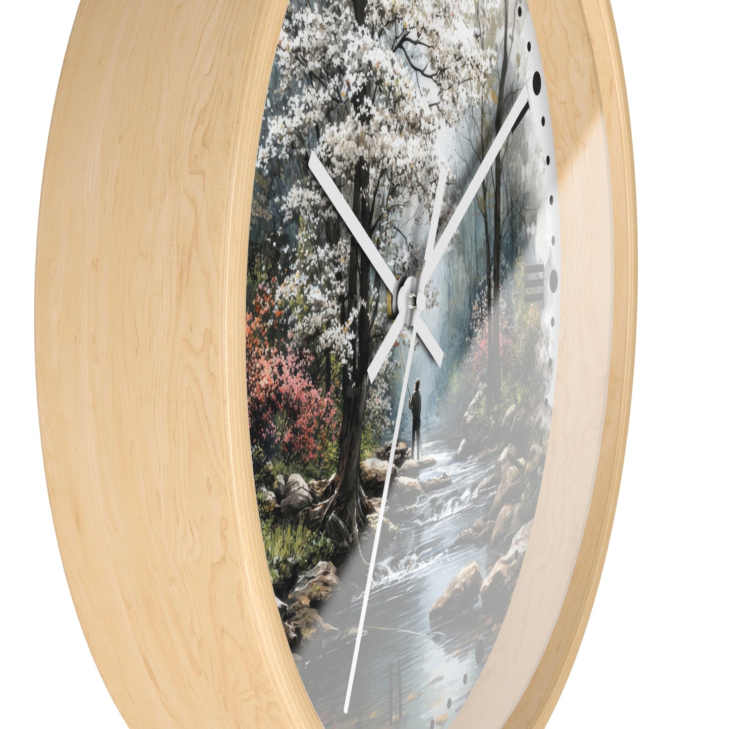 Round wall clock with a light natural wood frame and a printed scenic forest watch face showing a stream, trees, and white blossoms.