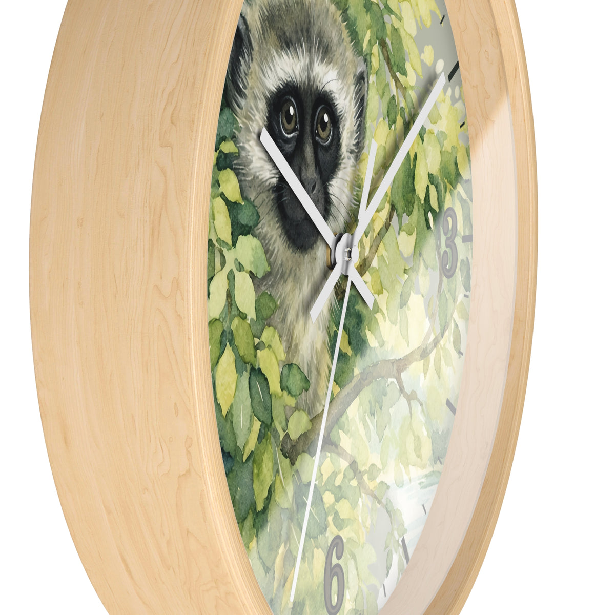 Round wall clock with a light natural wood frame and a printed face featuring a vervet monkey among green leaves, shown on a white background.