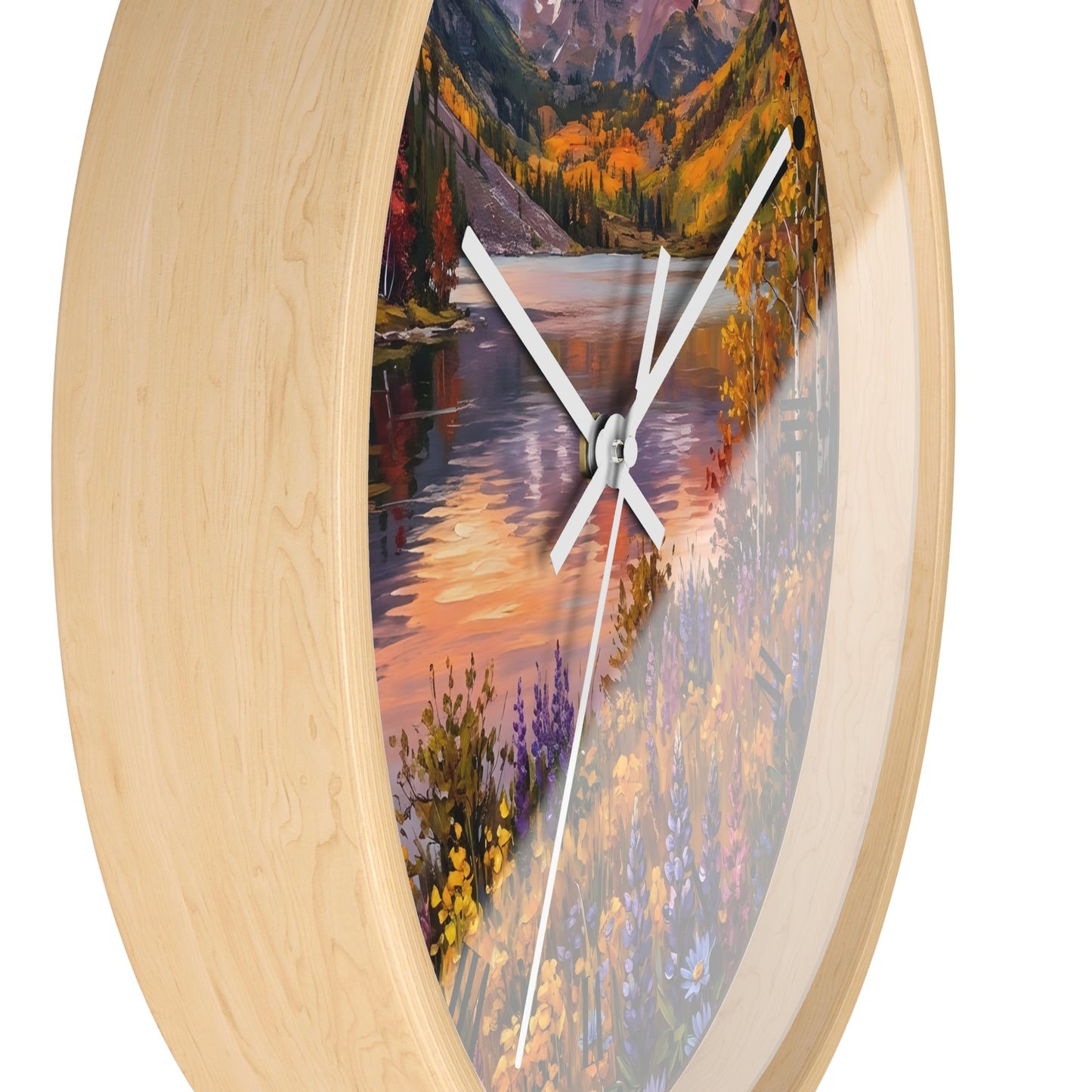 Round wall clock with a light natural wood frame and a scenic landscape print featuring a river, mountains, and wildflowers, with white clock hands on a white background.