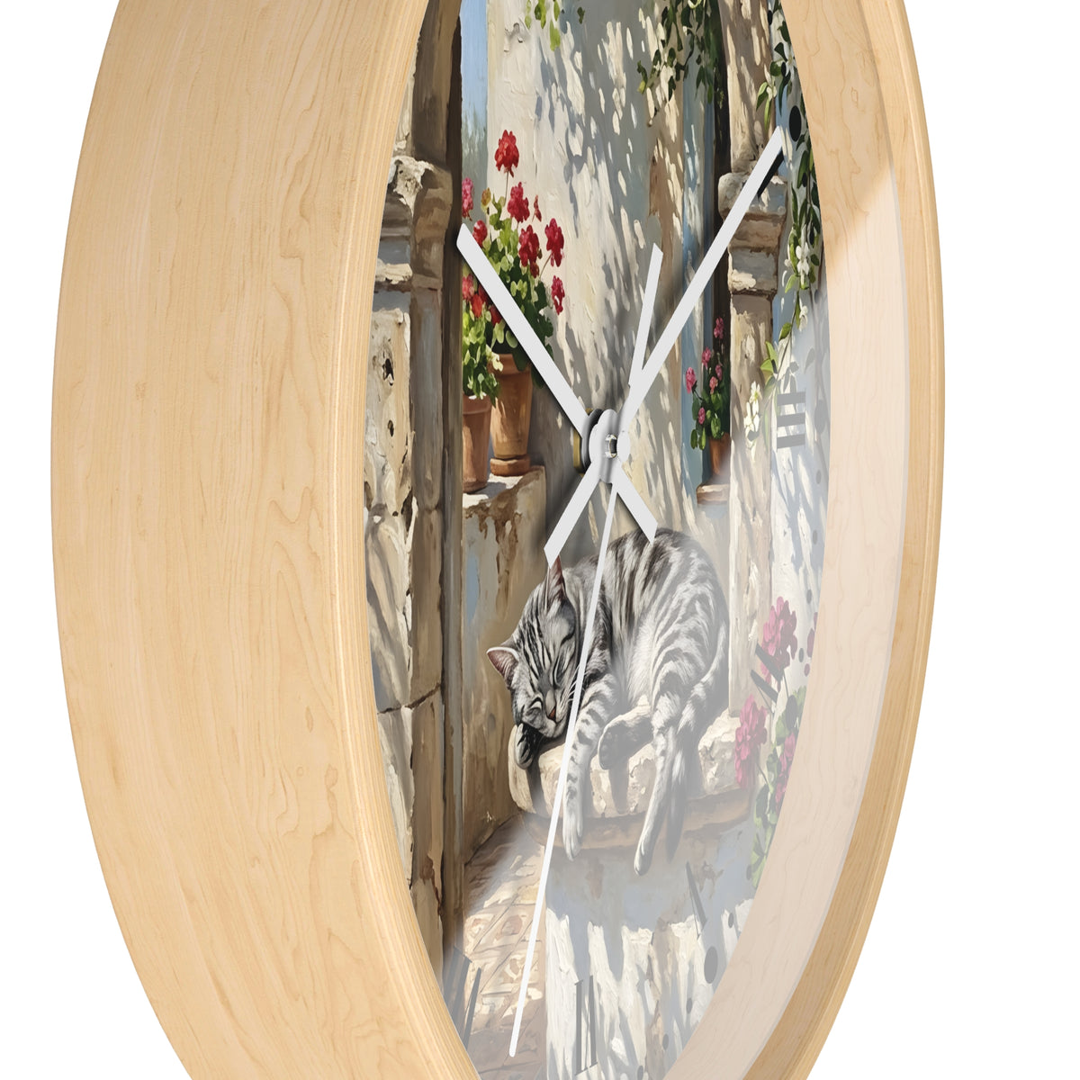 Oval wall clock with a light natural wood frame and a printed scene of a gray tabby cat lounging on a sunlit balcony with red flowers and green vines.