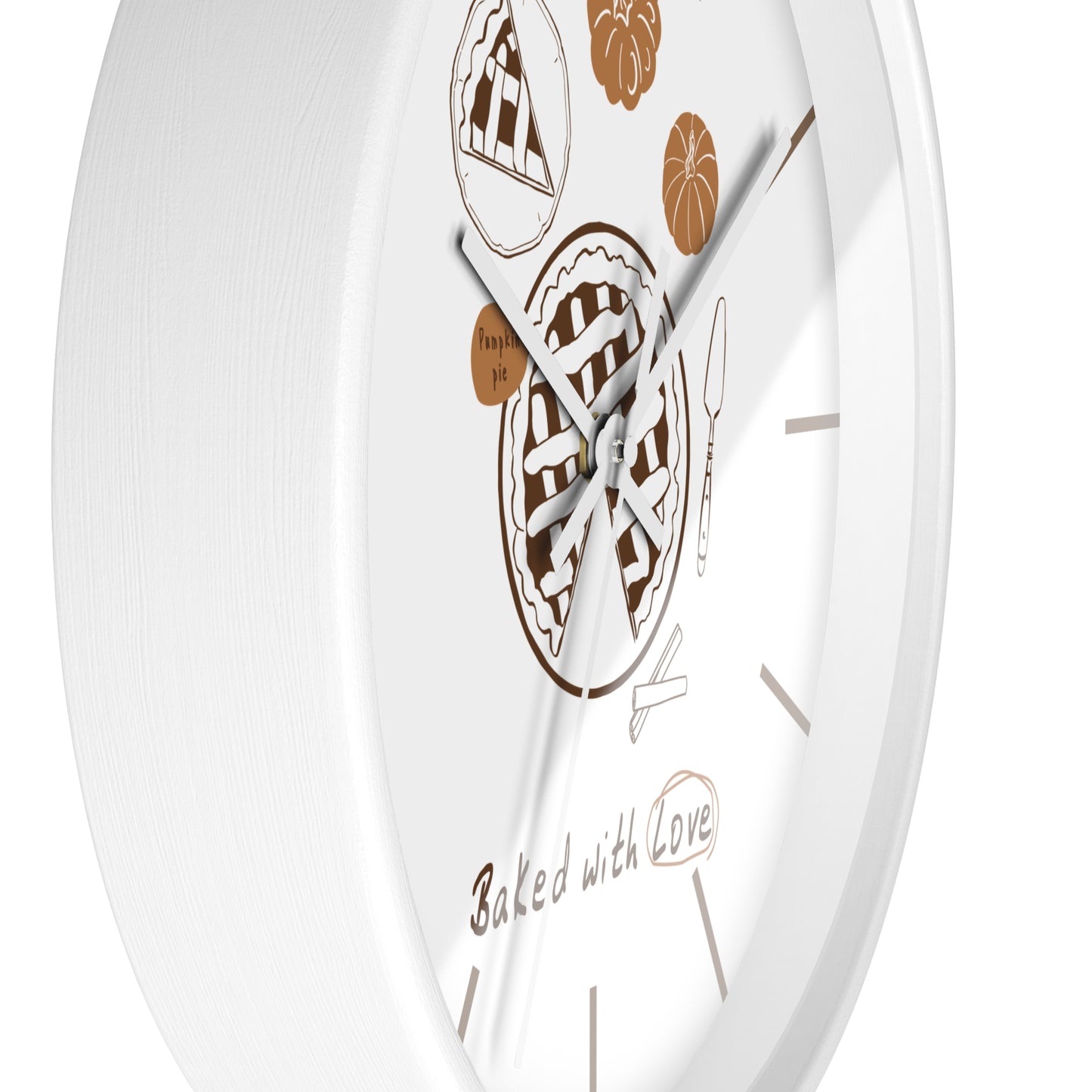 A white round wall clock with brown pie illustrations and the phrase 'Baked with Love' on the face, shown against a white background.