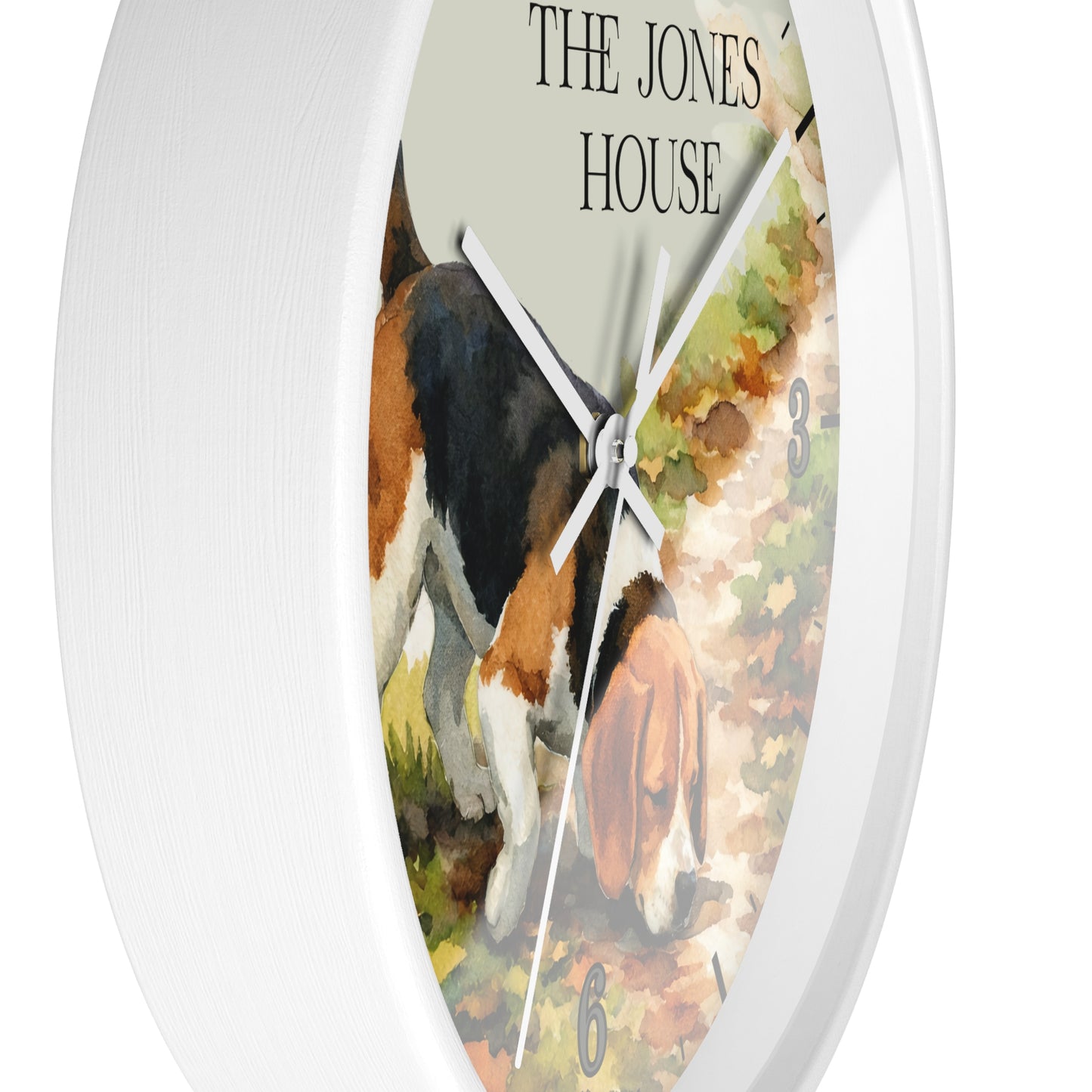 A round white wall clock with a printed illustration of a black, white, and tan dog on the face, with the text 'THE JONES HOUSE' at the top and a white outer rim.