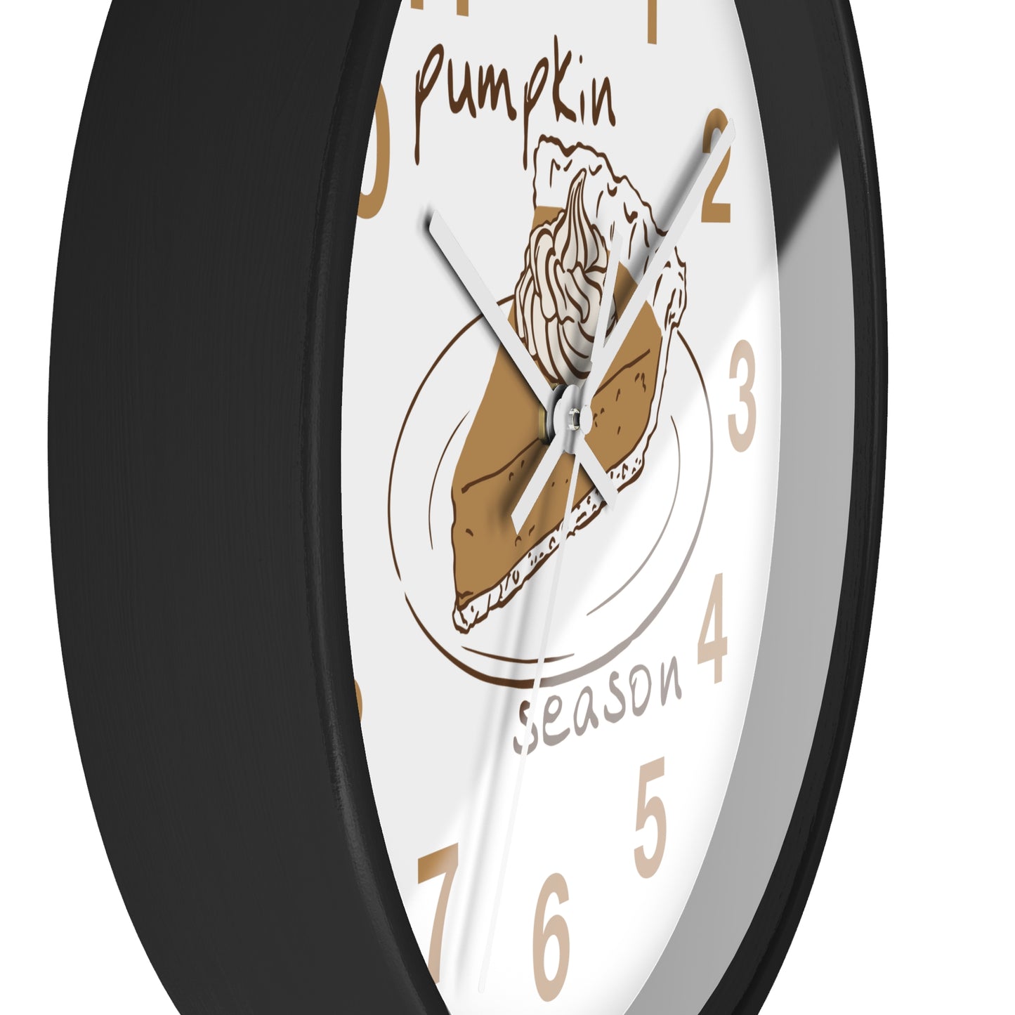A close-up of a round wall clock with a black frame and a white face featuring a pumpkin pie illustration and the words 'Pumpkin Season' in tan lettering.