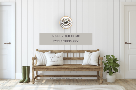 A butterfly-design wood clock with a natural frame hung above a rustic wooden entryway bench styled with white pillows in a bright shiplap mudroom.