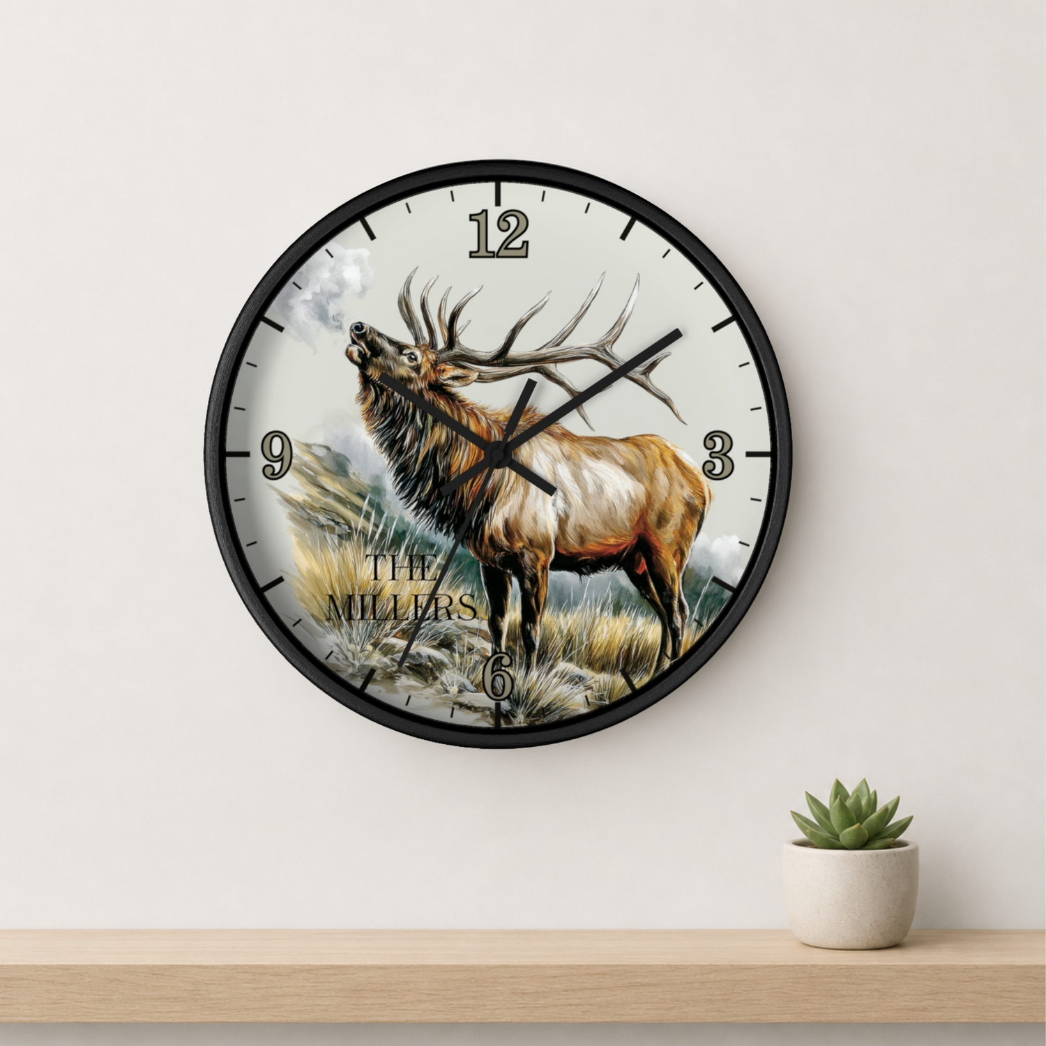 Round natural wood wall clock with the hand drawn design of a hand pouring syrup on a cinnamon roll and text 'The joy of Autumn' on a wall.