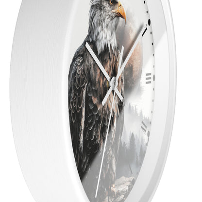 A white round wall clock featuring a printed design of a bald eagle over a misty mountain landscape, shown against a plain white background.