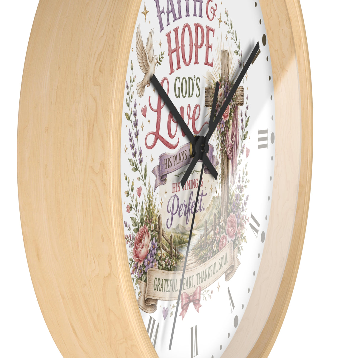 A round wall clock with a light natural wood frame and a white face featuring a religious design with the words 'Faith & Hope God's Love' and floral illustrations.