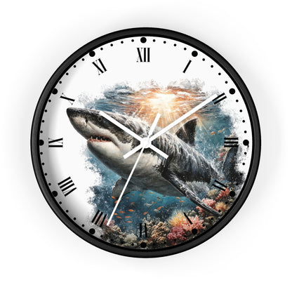 Round wall clock with a black frame and Roman numerals, featuring a printed design of a great white shark swimming over an underwater coral reef on a white clock face.