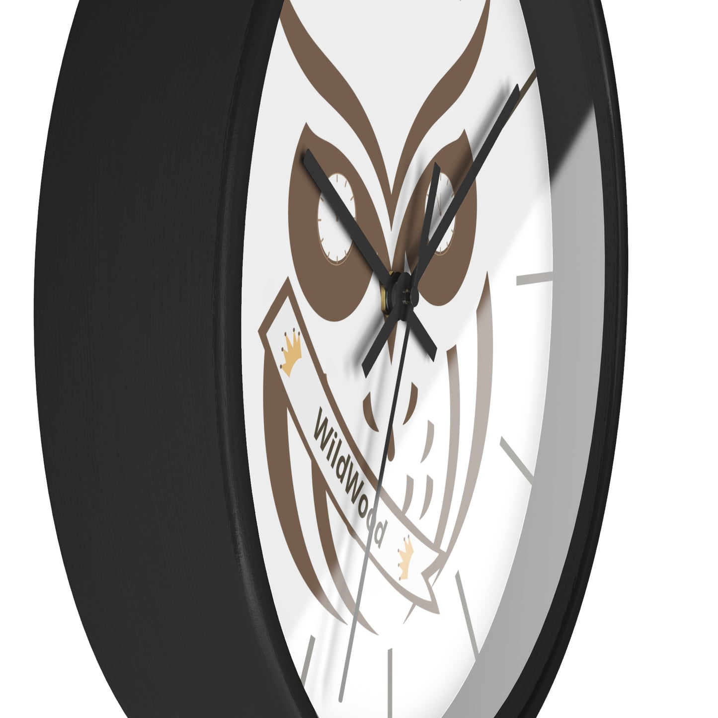A close-up of a round wall clock with a black frame and a white face featuring a brown owl graphic and the words 'Wildwood' on a banner.