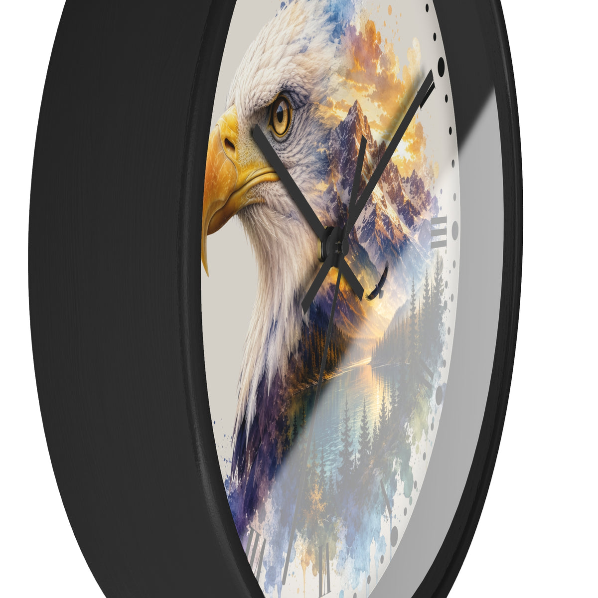 A round wall clock with a black frame and a white dial featuring a detailed bald eagle head layered over a colorful mountain and forest landscape. The clock is shown at an angle against a plain white background.