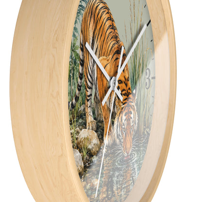 Round wall clock with a light natural wood frame and a printed tiger drinking water scene on the face, shown against a plain white background.