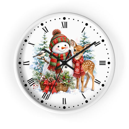 A round white wall clock with a festive Christmas illustration on the face, featuring a snowman in a red and green striped knit hat and scarf, a deer in a red sweater, evergreen trees, and a bird perched on the clock hand. The clock has black Roman numerals, black dot hour markers, and black hands on a white background.