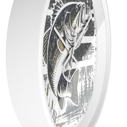 A white oval wall clock featuring a detailed black and gray graphic print of a largemouth bass fish with subtle gold accents, shown against a clean white background.