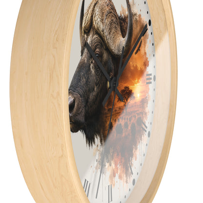 Round wall clock with a light natural wood frame and a printed face featuring a bison head over an orange sunset landscape, shown on a white background.