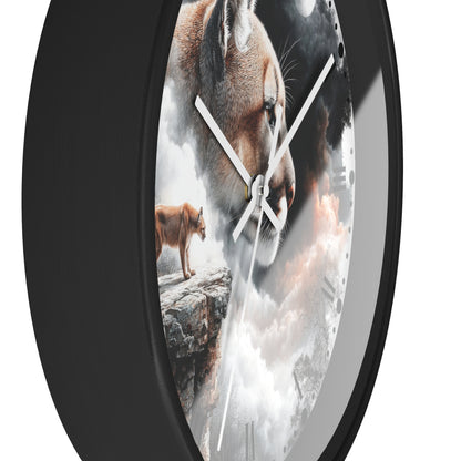 A round wall clock with a matte black frame and a printed face featuring a large cougar head, a smaller cougar standing on a rock, and dramatic clouds. White clock hands are visible against a white background.