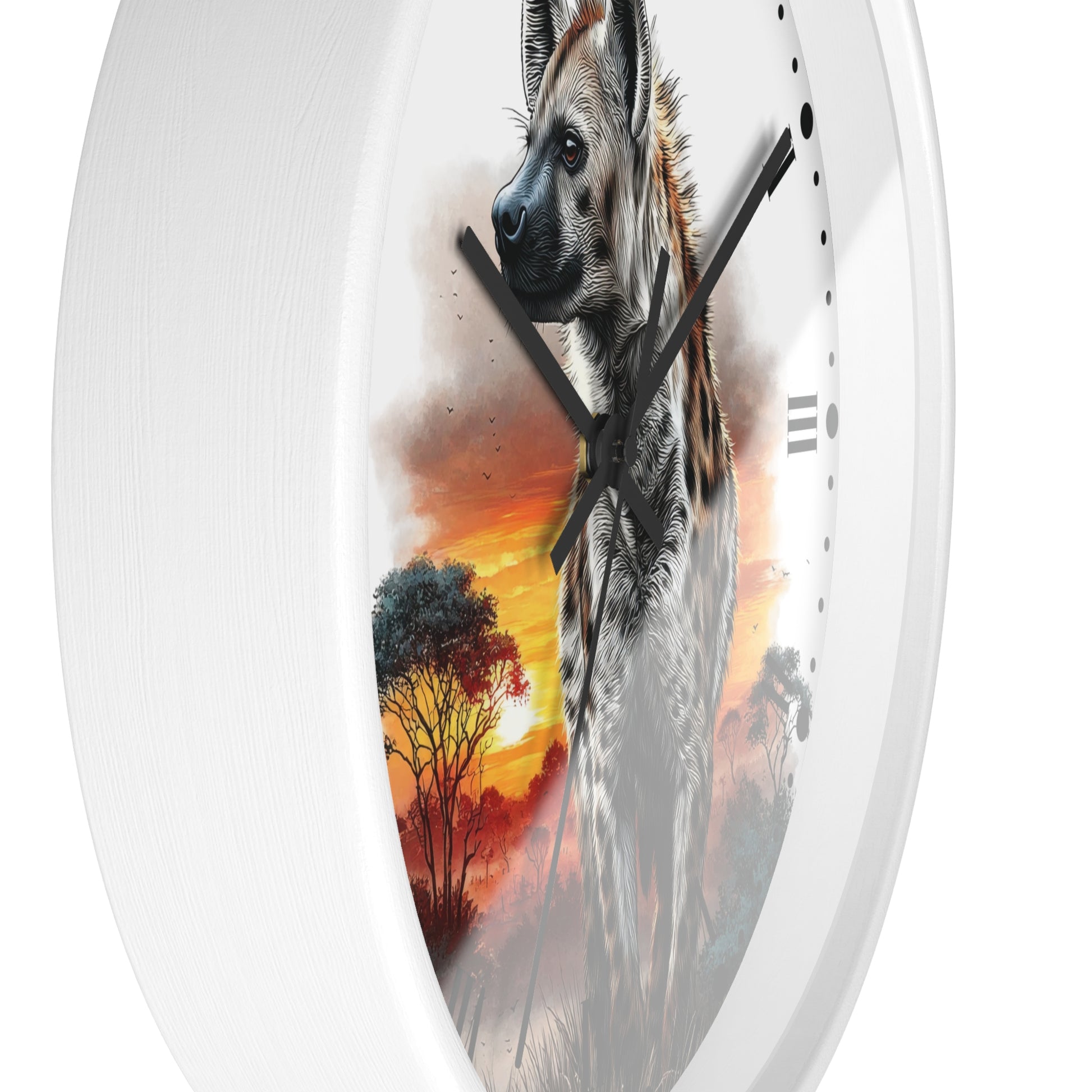 A white oval wall clock featuring a printed design of a hyena in profile against a warm orange and yellow sunset with trees, shown against a plain white background.