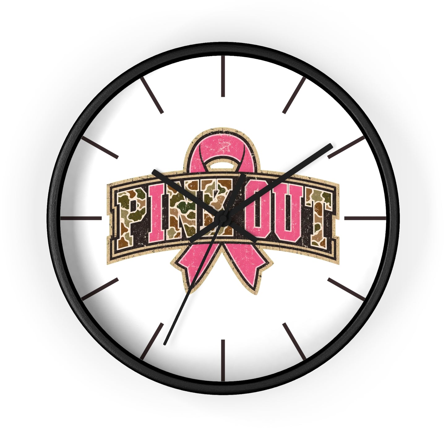 A round wall clock with a black frame and white face, featuring a pink breast cancer awareness ribbon and the words 'PINK OUT' in leopard-print lettering. The clock is shown against a plain white background.