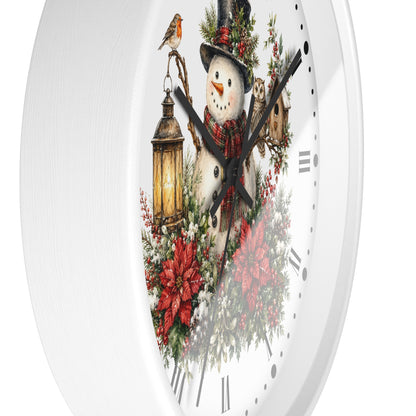 A round white wall clock with a festive Christmas illustration on the face, featuring a snowman in a top hat, a lantern, poinsettias, holly, and a small bird, shown against a white background.
