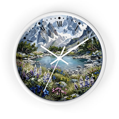 Round wall clock with a white frame and a scenic landscape print featuring snow-capped mountains, a lake, and wildflowers, with white clock hands and black Roman numerals.
