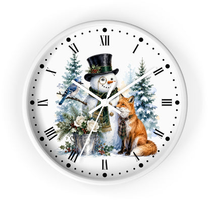 A round white wall clock with a festive winter illustration on the face, featuring a snowman in a black top hat, a red fox, a bluebird, evergreen trees, and Roman numerals for hour markers.