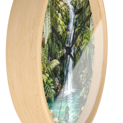 Round wall clock with a light natural wood frame and a printed scenic face showing a lush green waterfall and pool, with black hands and a visible numeral 6.