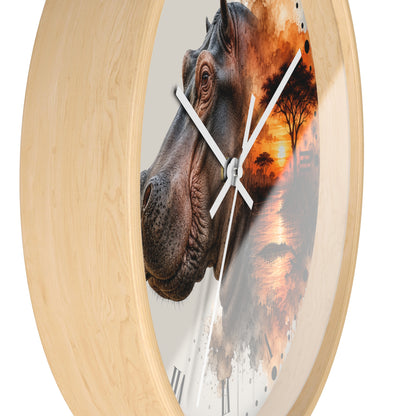 Round wall clock with a light natural wood frame and a printed face featuring a close-up hippopotamus head layered over an African savanna sunset scene, with white clock hands.
