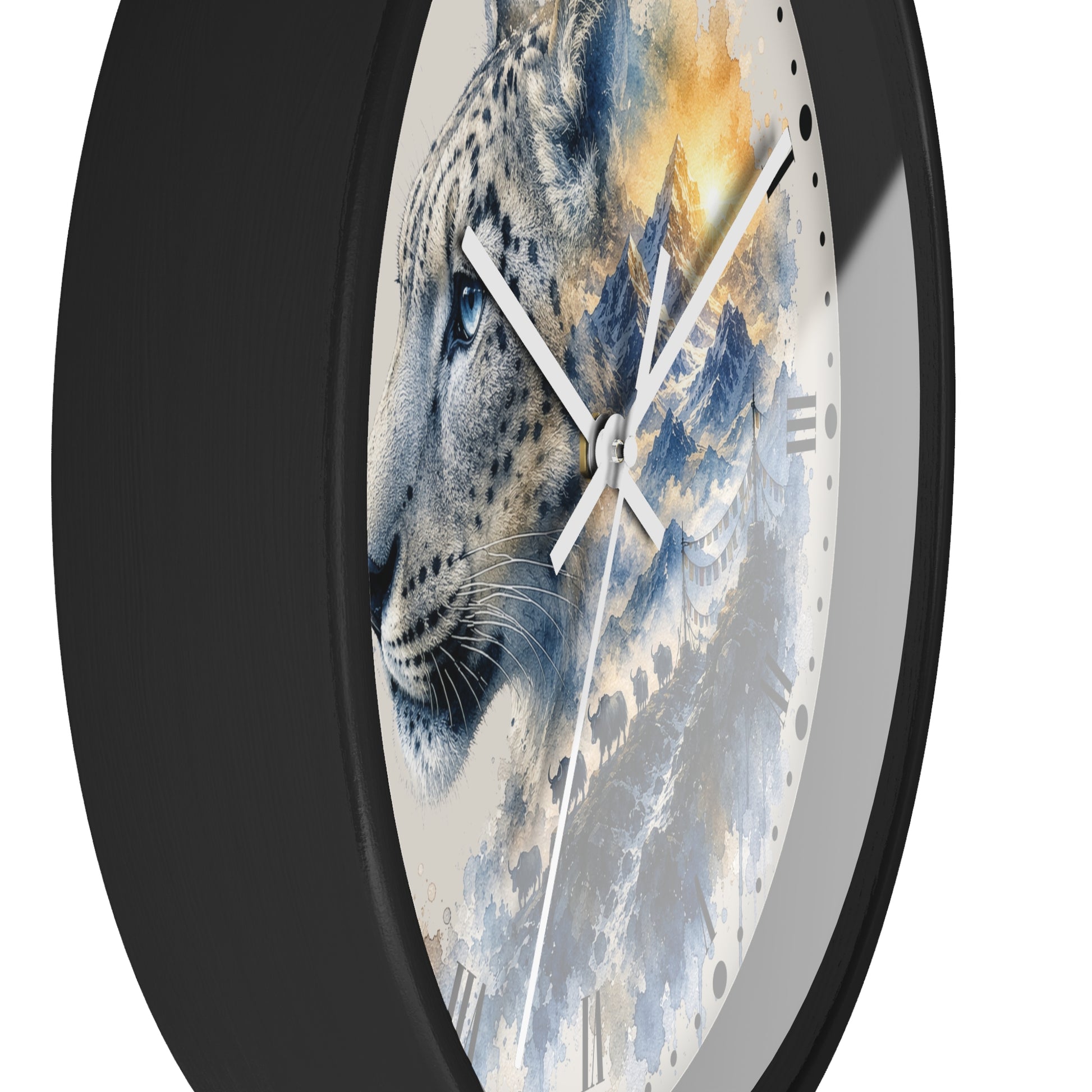 A round wall clock with a black frame and a printed face featuring a snow leopard in profile over blue-gray mountains with warm golden highlights, shown against a plain white background.