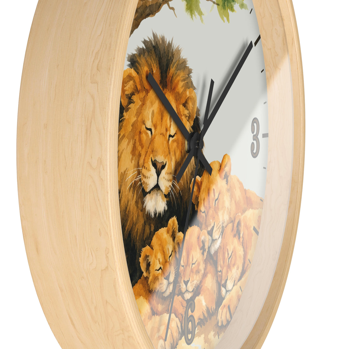 A round wall clock with a light natural wood frame and a printed lion family illustration on the face, including a large male lion, lionesses, tree branches, and black clock hands.