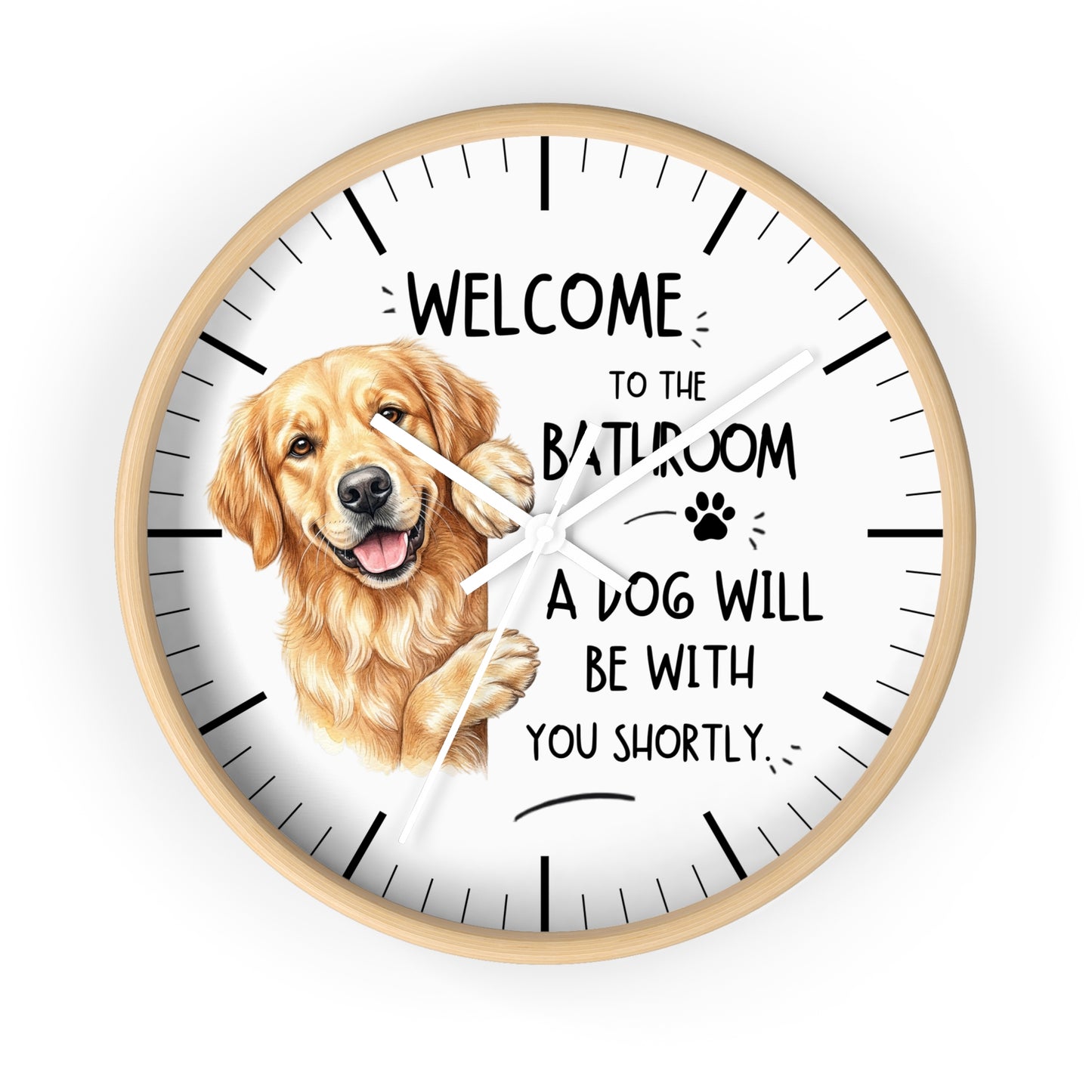 A round wall clock with a light wood frame and a white face, featuring a golden retriever illustration and the text 'WELCOME TO THE BATHROOM A DOG WILL BE WITH YOU SHORTLY.' on a plain white background.