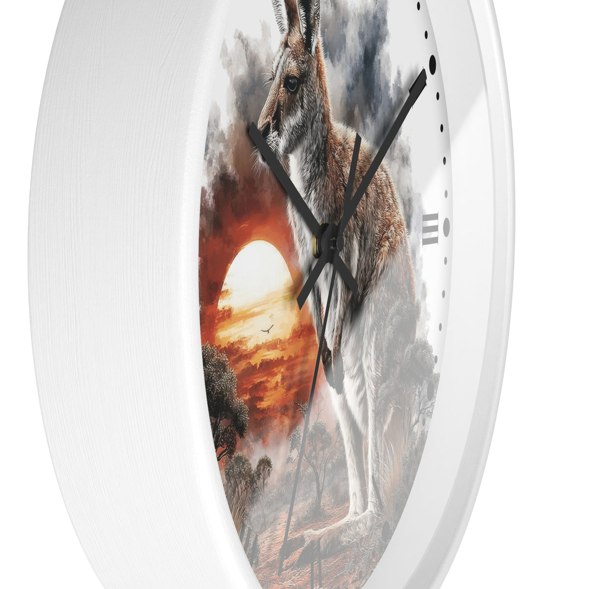 A white oval wall clock featuring a printed scenic design of a kangaroo standing in a dramatic sunset landscape with a glowing sun and dark clouds.
