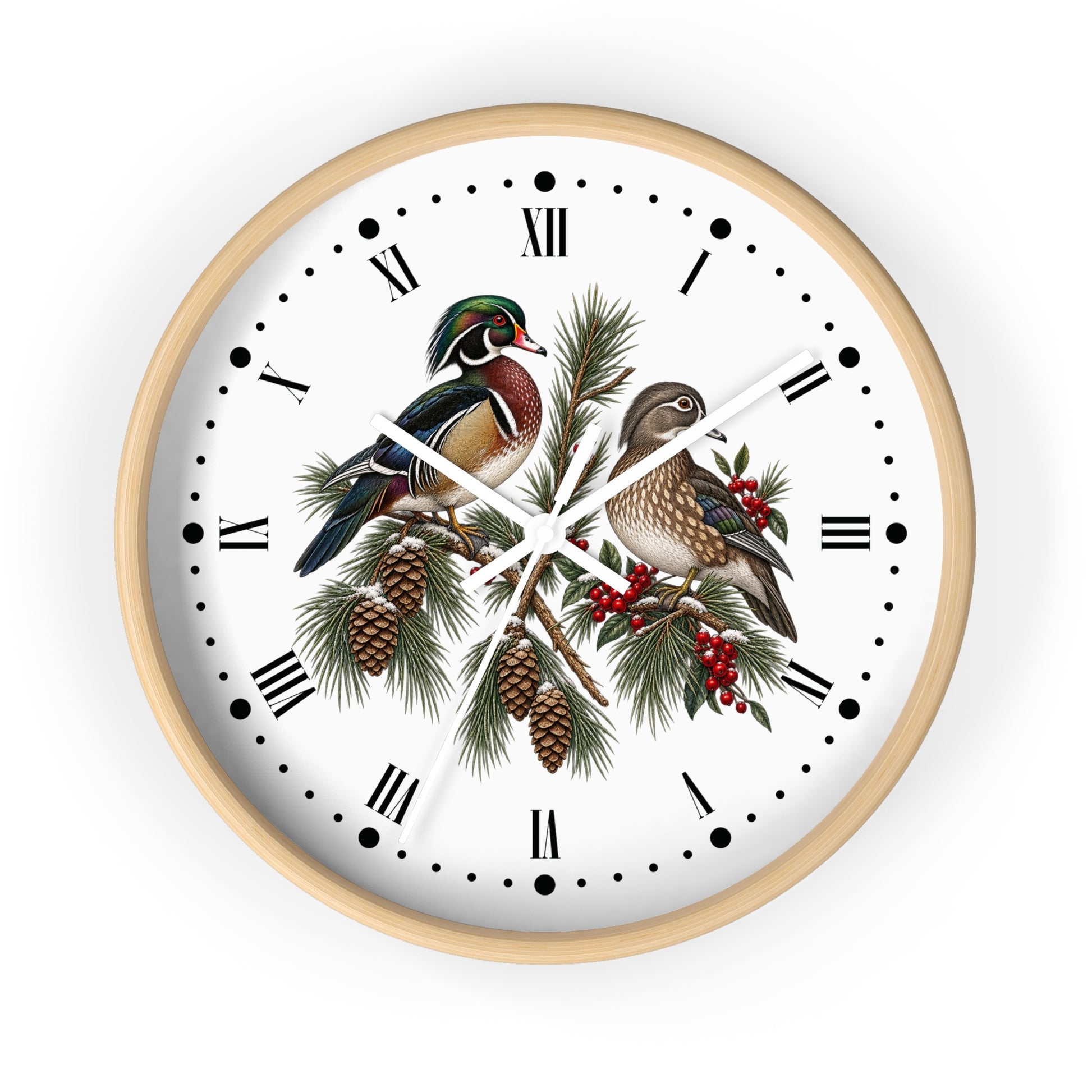 A round wall clock with a light natural wood frame, featuring a white face decorated with an illustration of two wood ducks perched on pine branches with pinecones and red berries, set against a plain white background.