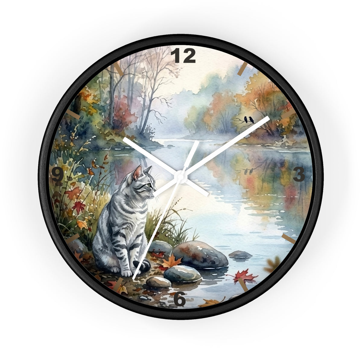 A round wall clock with a black frame and a printed scenic design featuring a gray tabby cat sitting by a river in autumn foliage. The clock face includes white clock hands, black numerals, and a light gray background around the product.