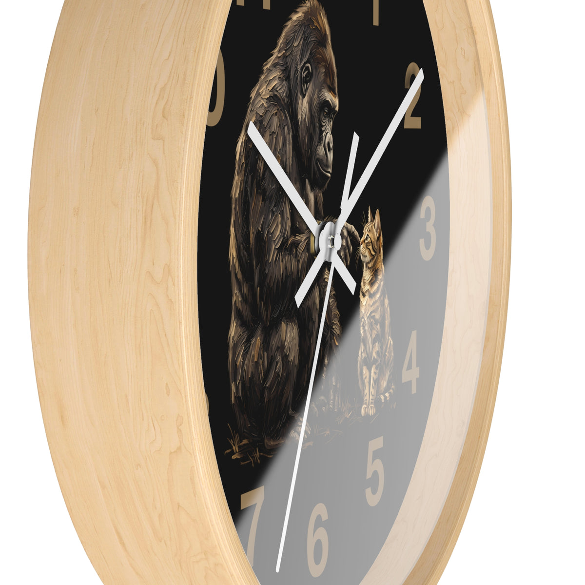 A round wall clock with a light natural wood frame and a black face featuring an illustration of a gorilla and a cat, with white hands and beige numerals.