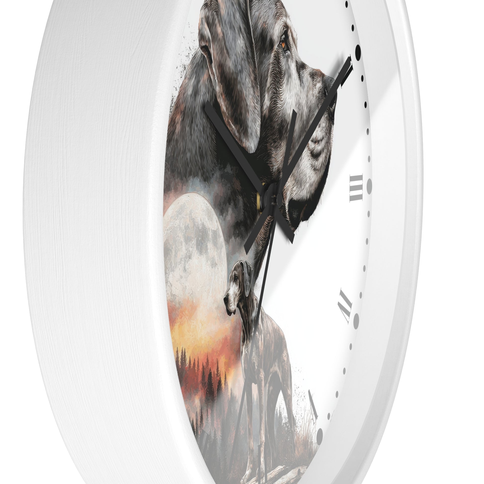 A round wall clock with a white frame and a printed dog-themed face. The artwork shows a large gray dog in profile, a smaller dog silhouette, a full moon, and a warm sunset landscape.