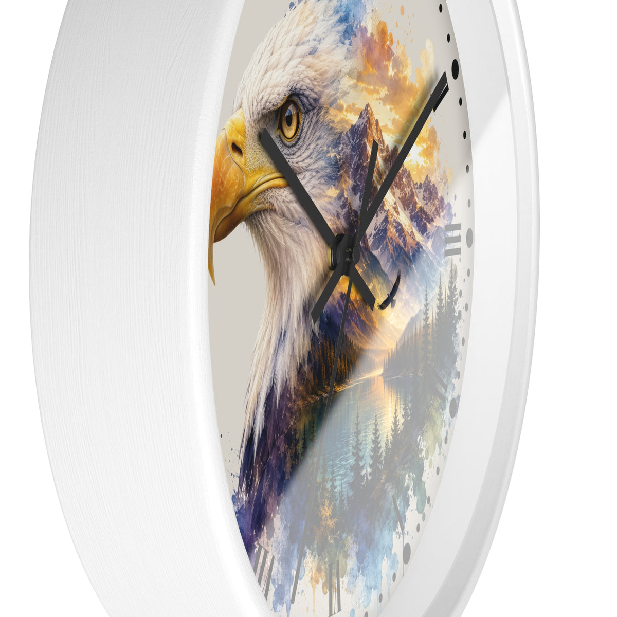 A white oval wall clock featuring a printed design of a bald eagle head layered over a colorful mountain and forest landscape. The clock has black hands and no visible brand name.