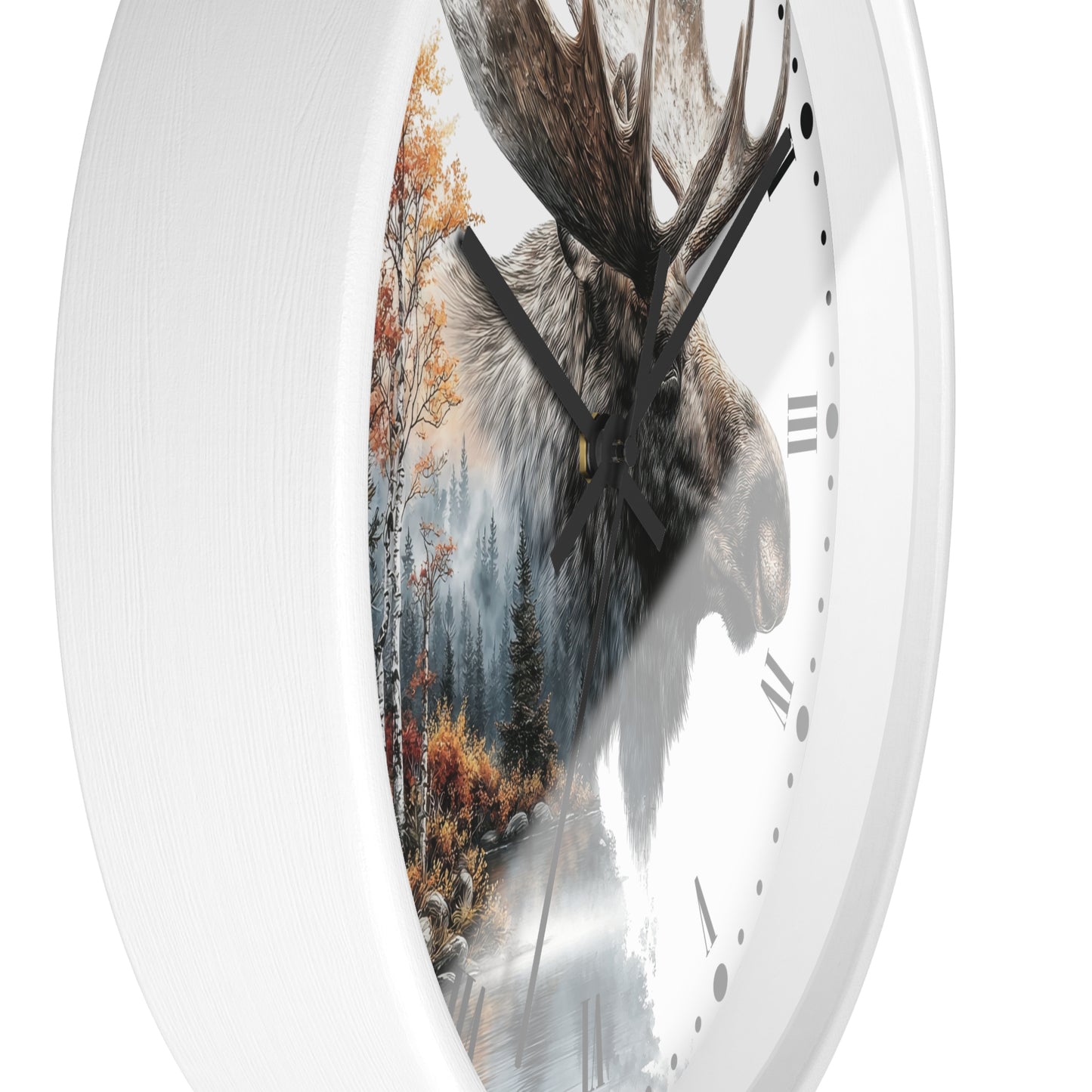 A round wall clock with a white frame and a printed design featuring a moose head over a misty forest scene with autumn trees. The clock is shown at an angle against a plain white background.