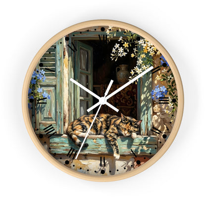 Round wall clock with a light natural wood frame, featuring a detailed illustration of a sleeping calico cat on a weathered blue window sill, surrounded by flowers and a rustic outdoor scene.