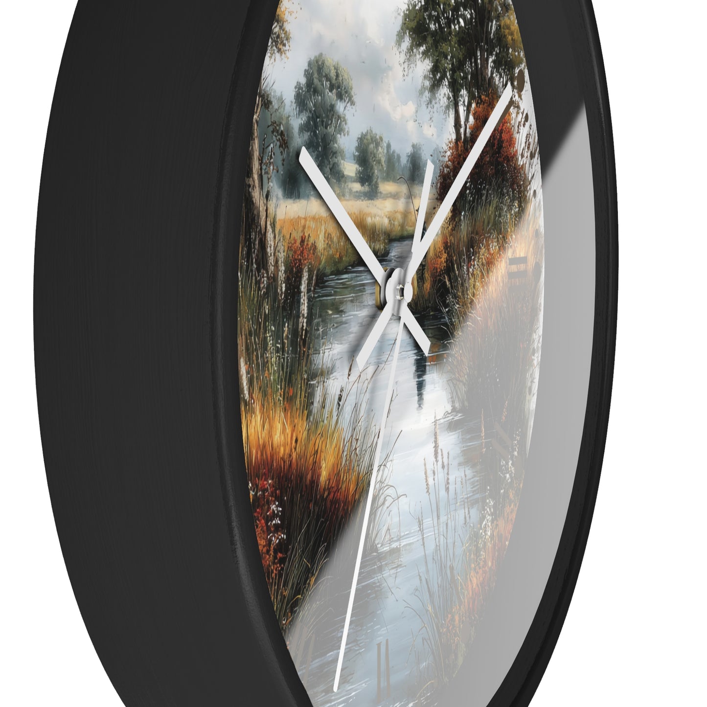 Round wall clock with a black frame and a scenic landscape print of a stream winding through tall grasses, featuring white clock hands on a white background.