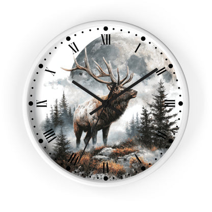 A round wall clock with a white frame and a scenic print of a large deer with antlers standing in a misty forest under a full moon. The clock face has black Roman numerals, black dot hour markers, and black clock hands.