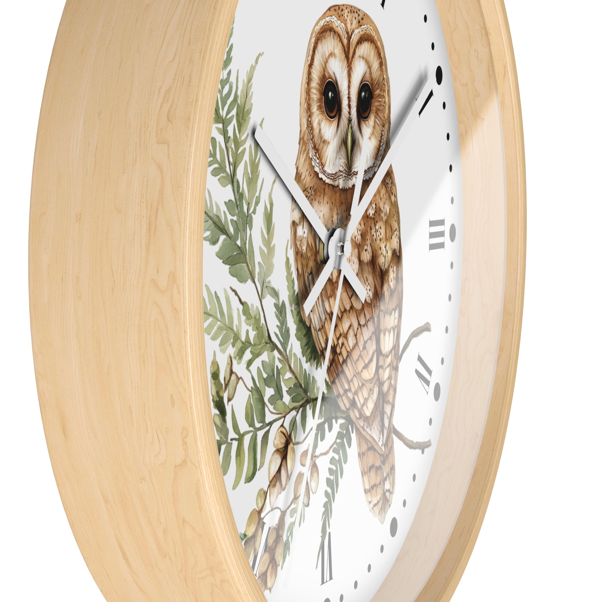 A round wall clock with a light natural wood frame and a white dial featuring a detailed illustration of a brown owl perched among green leaves.