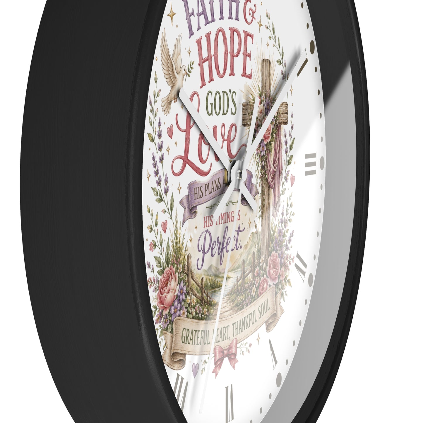 A round wall clock with a black frame and a white face featuring religious artwork and the words 'Faith & Hope God's Love His Plans His Timing is Perfect' with a cross, floral details, and Roman numerals.
