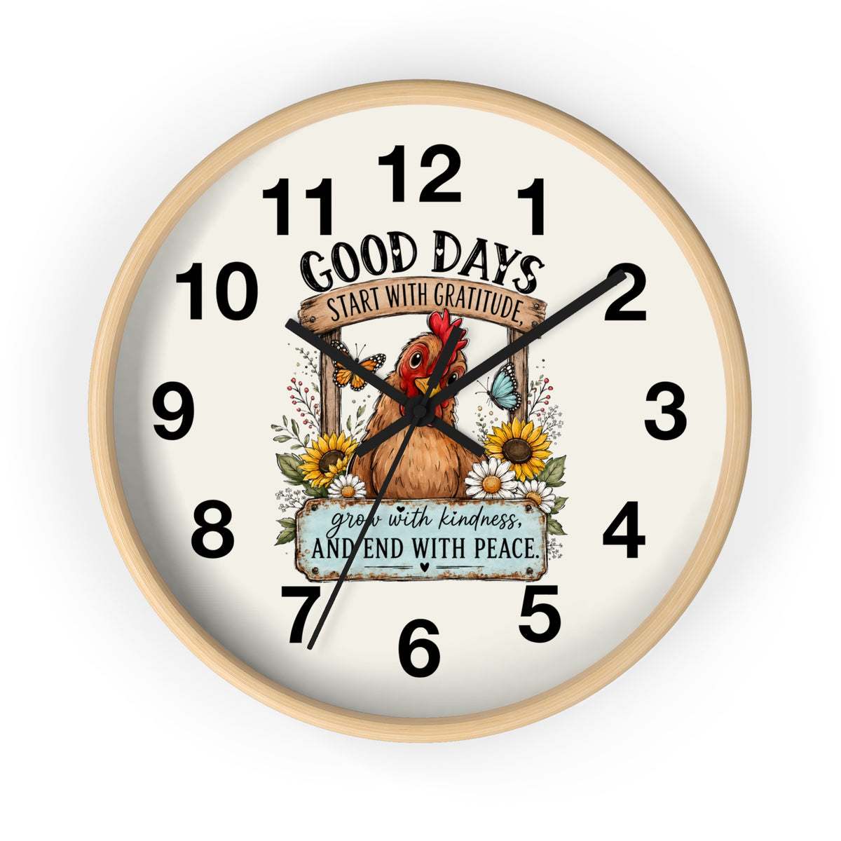 A round wall clock with a light natural wood frame and an off-white face, featuring a central illustration of a brown chicken surrounded by sunflowers and the text 'GOOD DAYS START WITH GRATITUDE' and 'grow with kindness AND END WITH PEACE'.