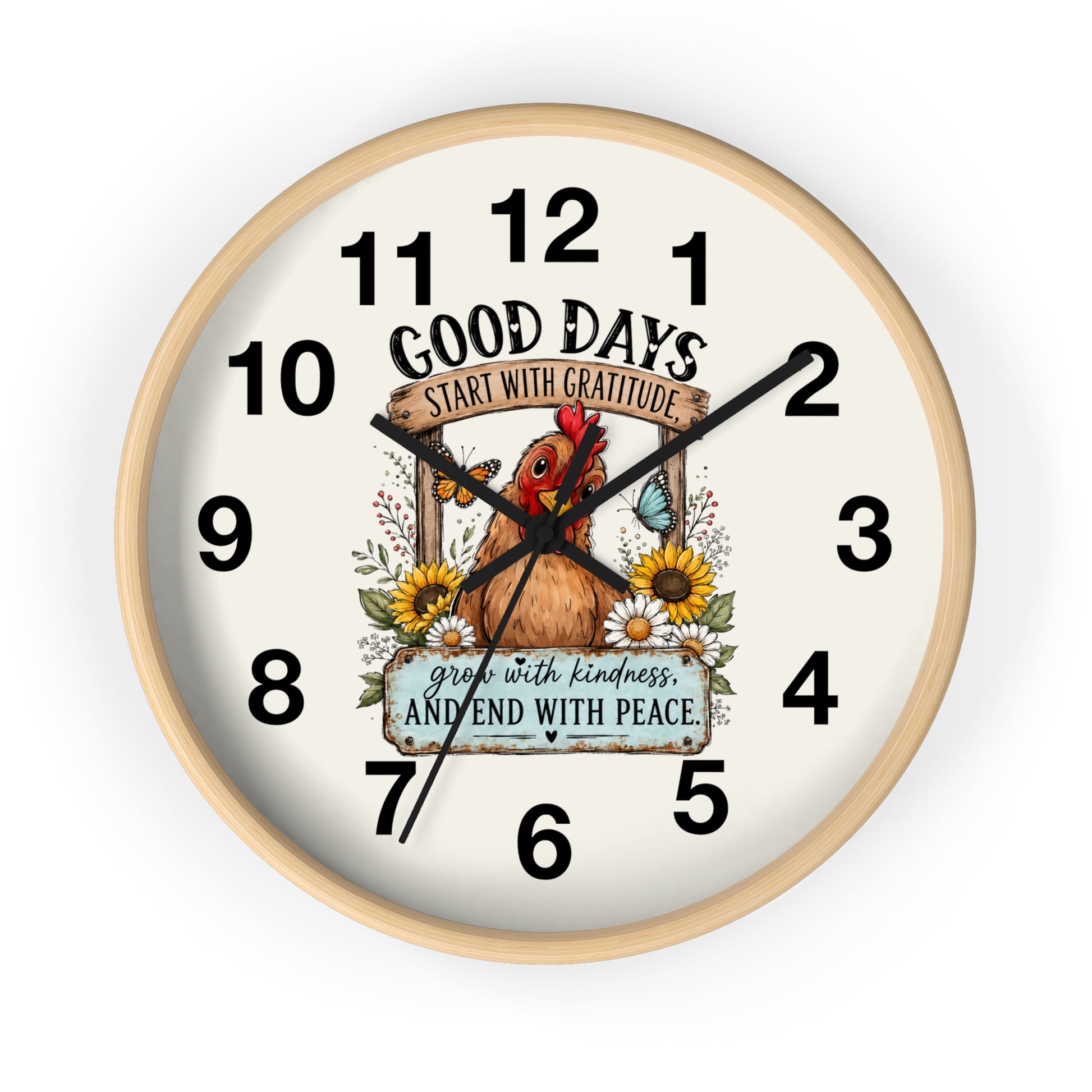 A round wall clock with a light natural wood frame and an off-white face, featuring a central illustration of a brown chicken surrounded by sunflowers and the text 'GOOD DAYS START WITH GRATITUDE' and 'grow with kindness AND END WITH PEACE'.