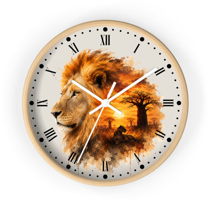 A round wall clock with a light wood frame and a printed design featuring a lion profile blending into an African savanna sunset scene with trees. The clock face is off-white with black Roman numerals, black hour markers, and white hands.