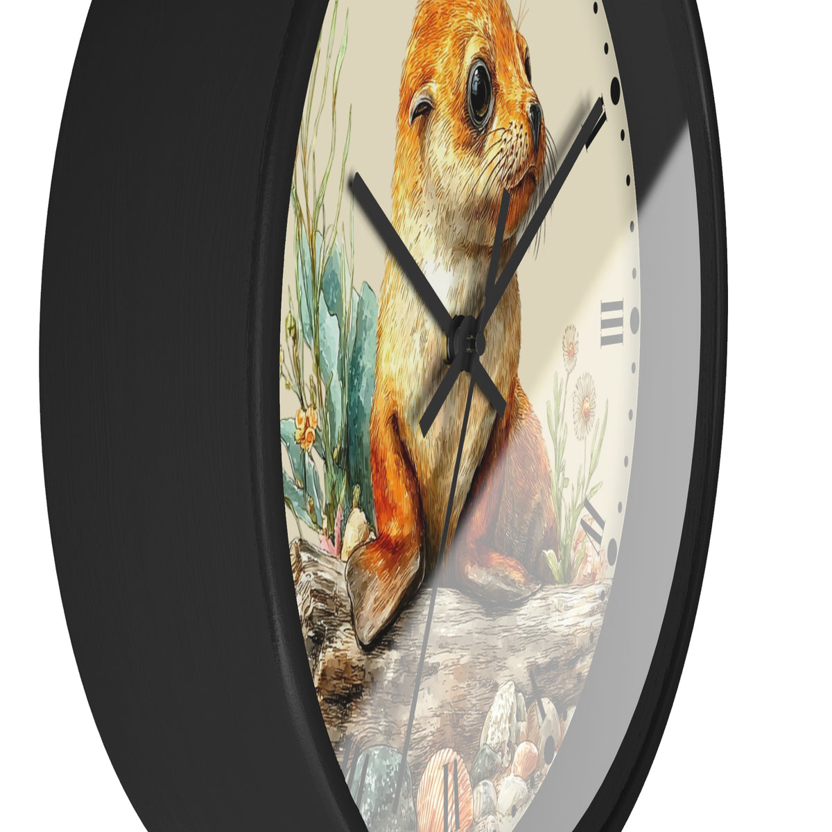 A close-up of a round wall clock with a black frame and a printed illustration of a seal  on the face, surrounded by cacti and rocks. The clock has black hands and Roman numeral hour markers.